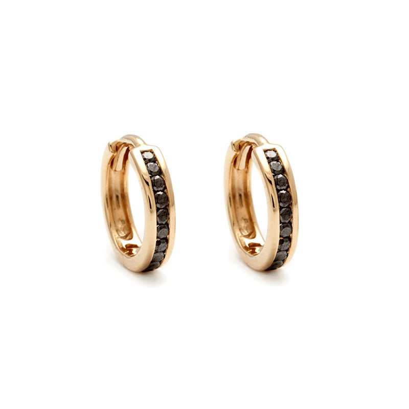 A pair of hoops with a line of black diamonds set in yellow gold.