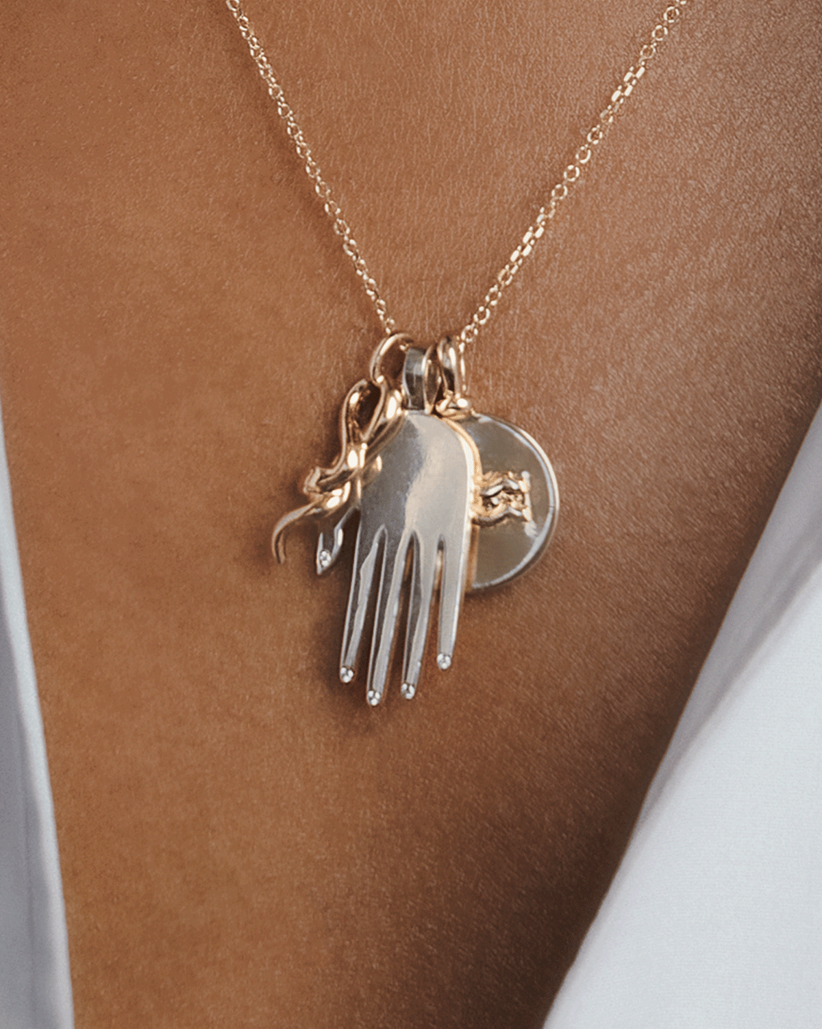 A model wears a necklace with talisman charms by Anna Sheffield.