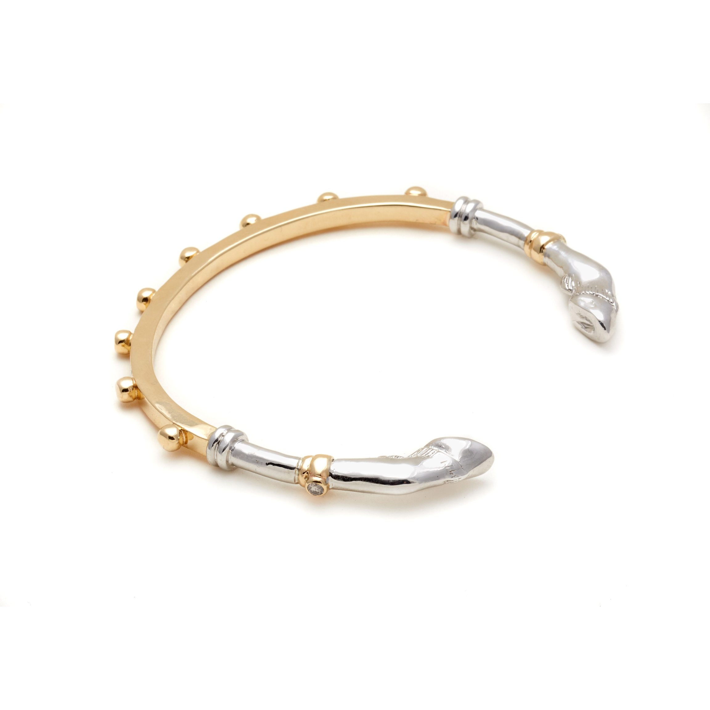 Yellow Gold & Sterling Silver 
Two-toned gold and silver bracelet on a white background