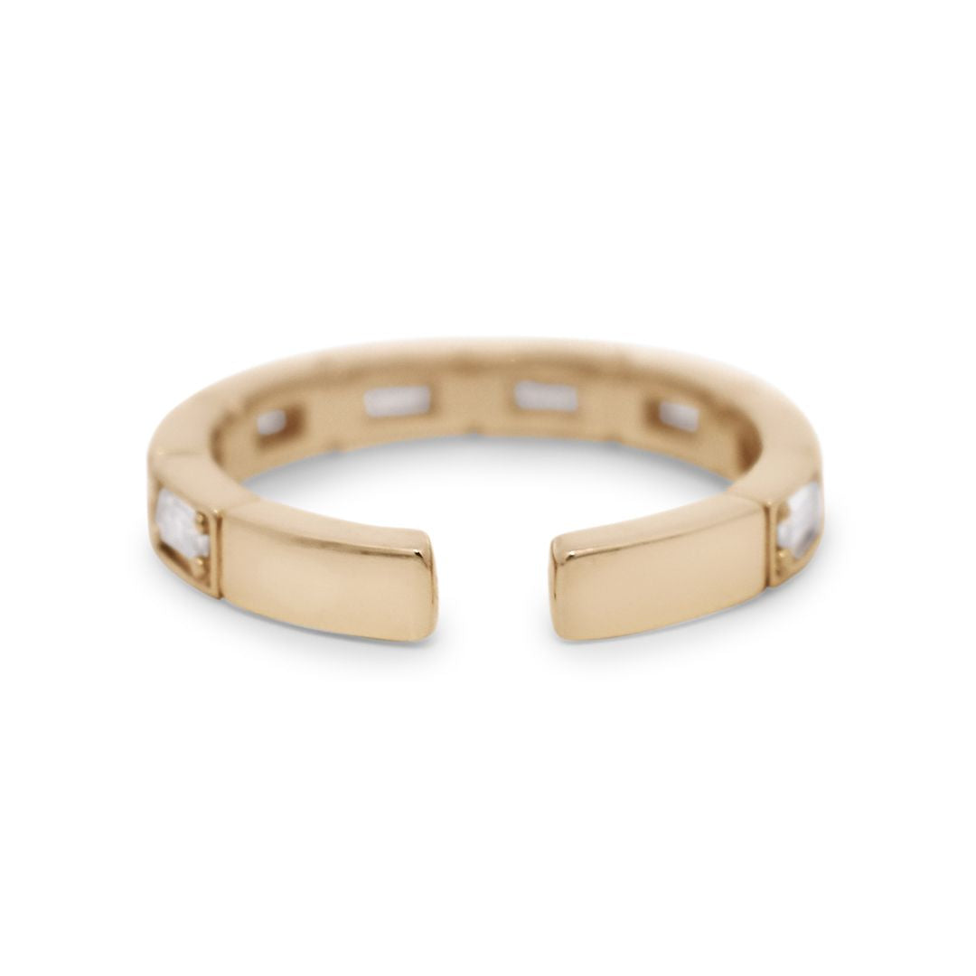 An ear cuff featuring white baguette diamonds set in 14kt yellow gold.