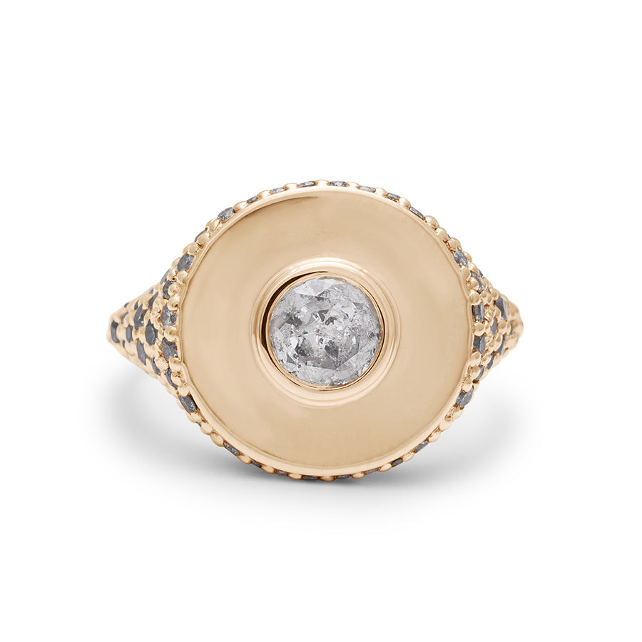 Front view of a round grey diamond bezel set in a signet style ring with white and grey diamond pave down the sides of the band set in yellow gold.