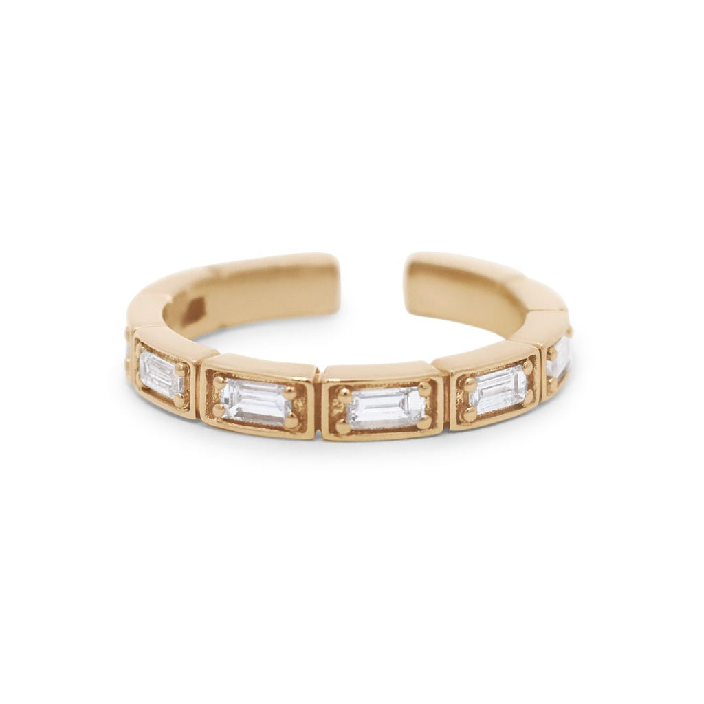 An ear cuff featuring white baguette diamonds set in 14kt yellow gold.