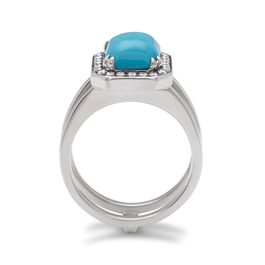 Side view of a double banded engagement ring with a emerald shape turquoise surrounded by a white diamond halo set in platinum.