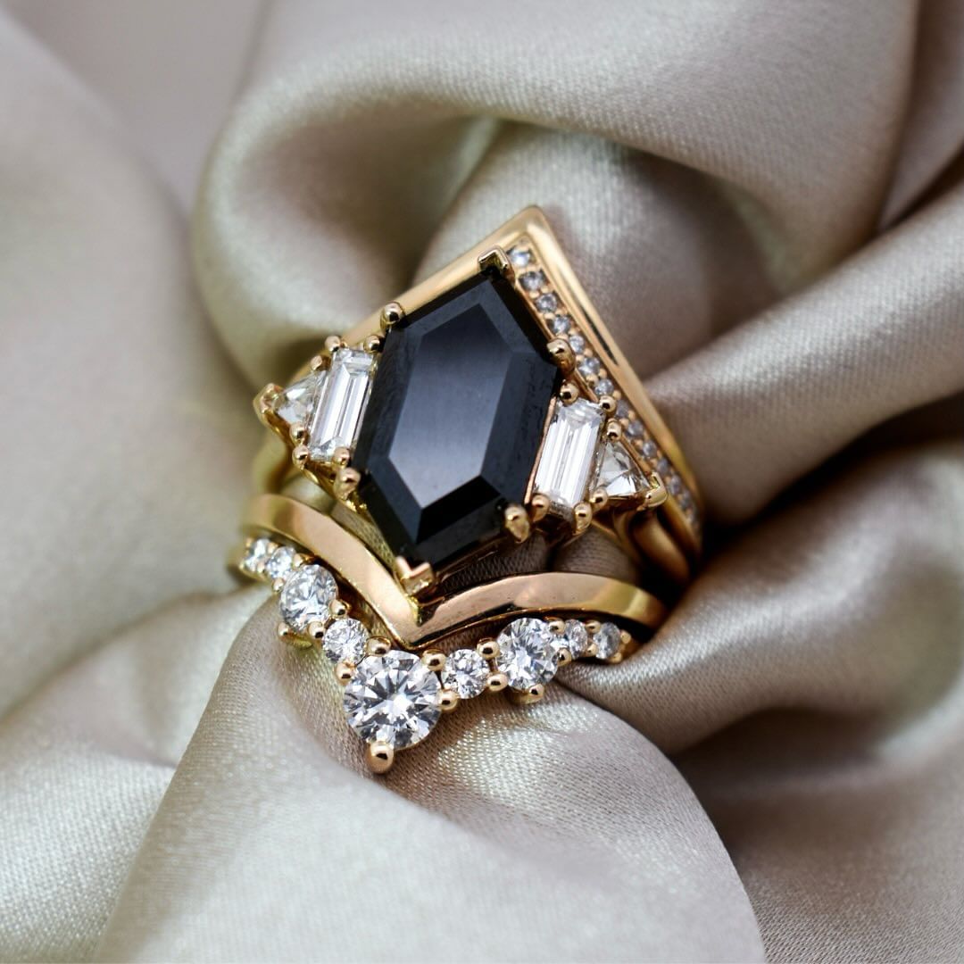 A nesting suite with a black diamond engagement ring.