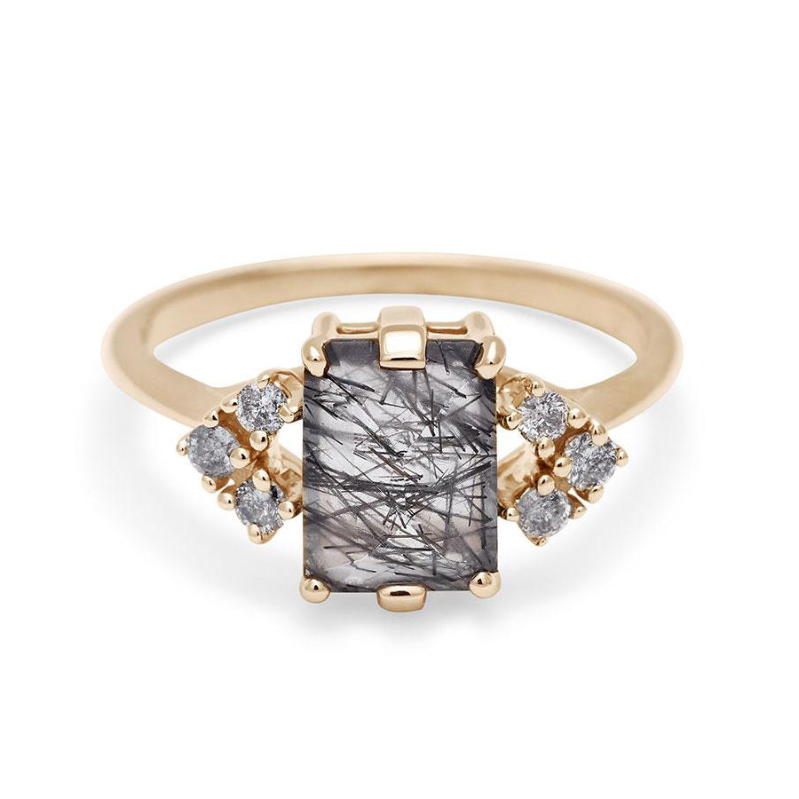 A ring with an emerald cut black rutilated quartz center with three round grey diamonds on either side in arrow shape, set in yellow gold., Yellow Gold