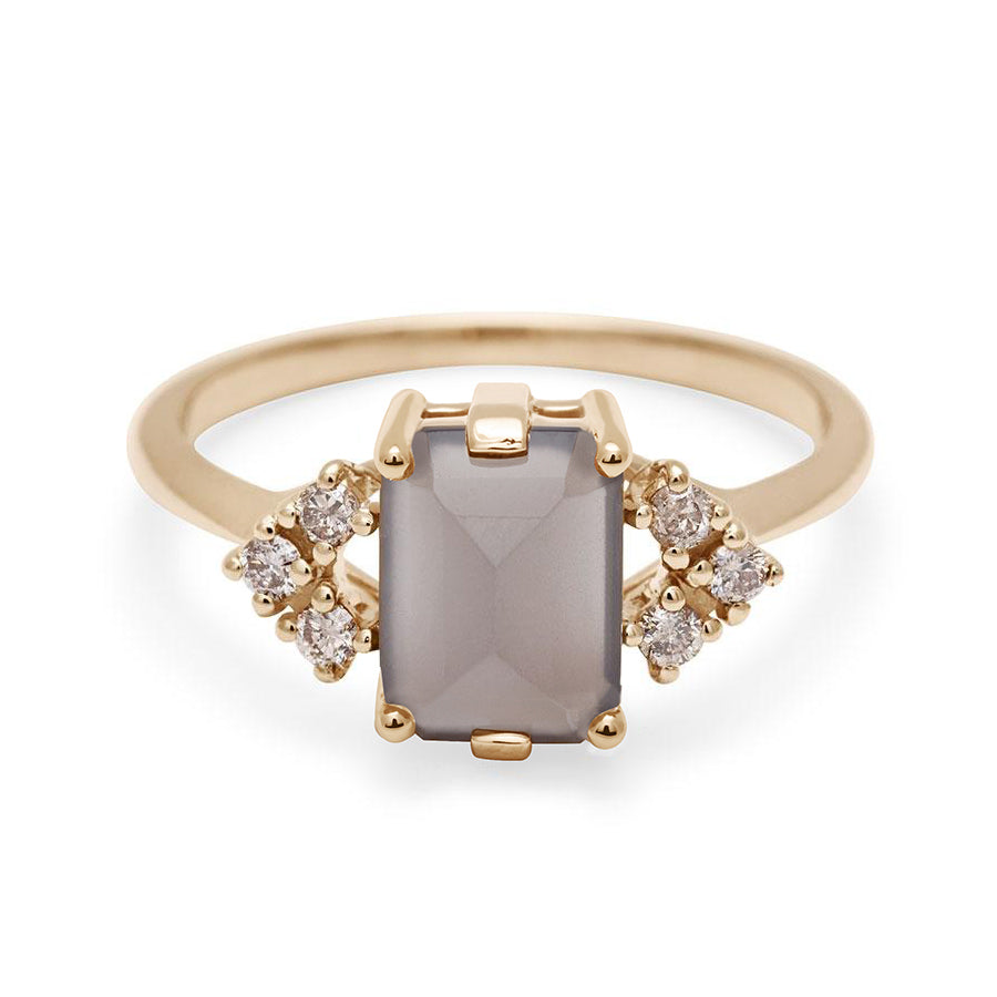 A ring with an emerald cut grey moonstone center with three round champagne diamonds on either side in arrow shape, set in yellow gold., Yellow Gold