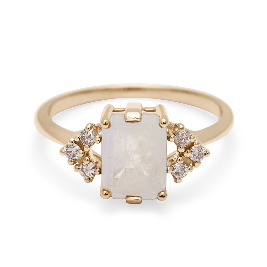 A ring with an emerald cut rainbow moonstone center with three round champagne diamonds on either side in arrow shape, set in yellow gold., Yellow Gold