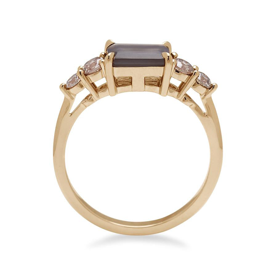Side view of a ring with an emerald shaped grey moonstone center stone with two round champagne diamonds on either side set in yellow gold., Yellow Gold