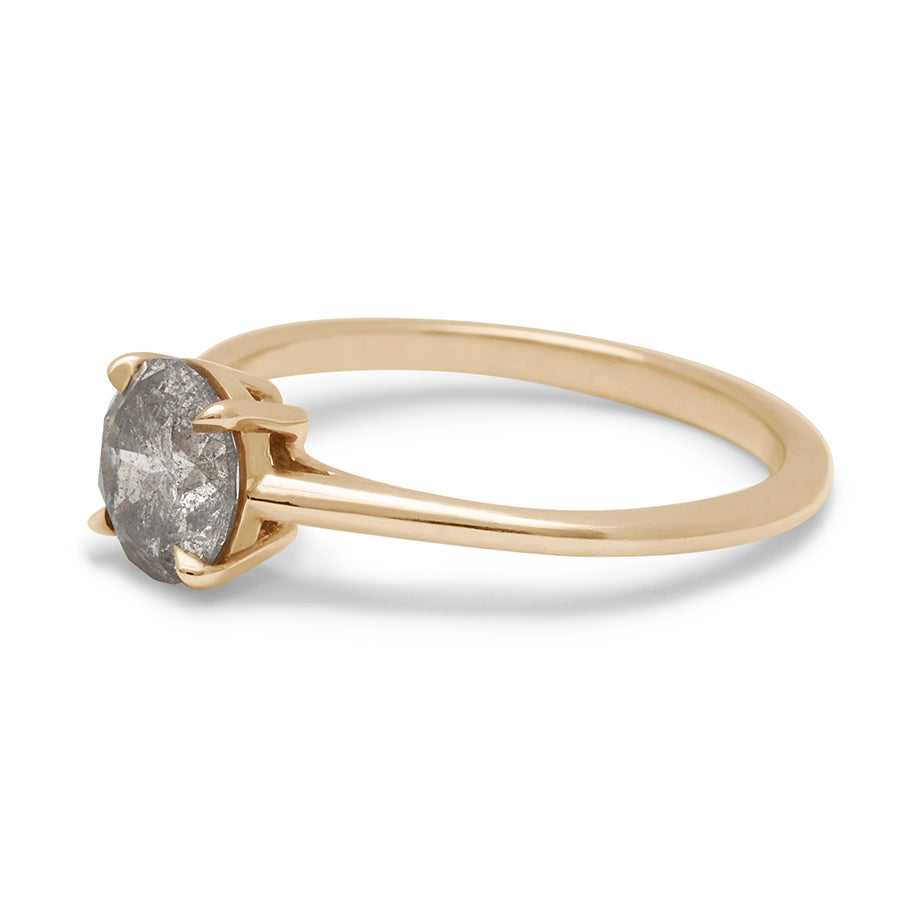 Angled view of a solitaire 1.00ct round grey diamond set in yellow gold.