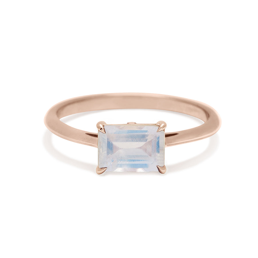 An east/west solitaire ring with an emerald shape rainbow moonstone set in rose gold., Rose Gold