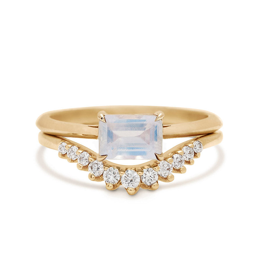 An east/west solitaire ring with an emerald shape rainbow moonstone set in yellow gold stacked on top of a white diamond nesting band., Yellow Gold, Rose Gold, White Gold