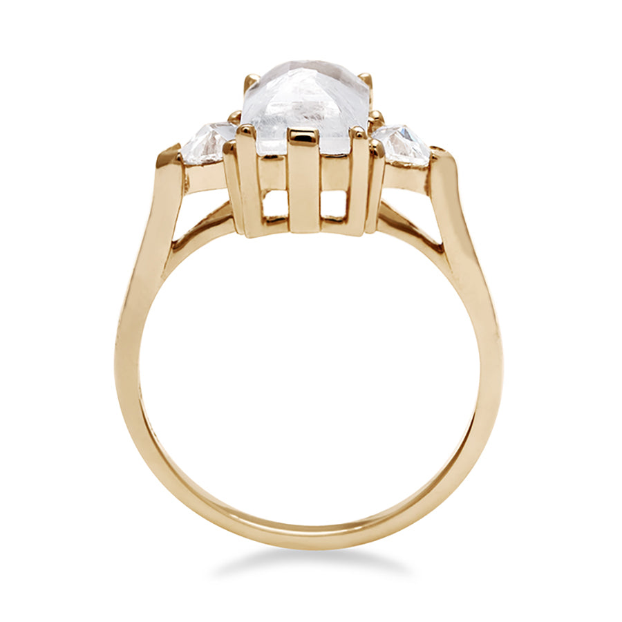 Side view of a three stone engagement ring with an emerald cut and emerald shape 8x6mm rainbow moonstone center stone with two white diamond trillion side stones set in yellow gold., Yellow Gold