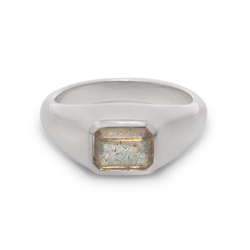 Silver ring with a rectangular stone on a white background