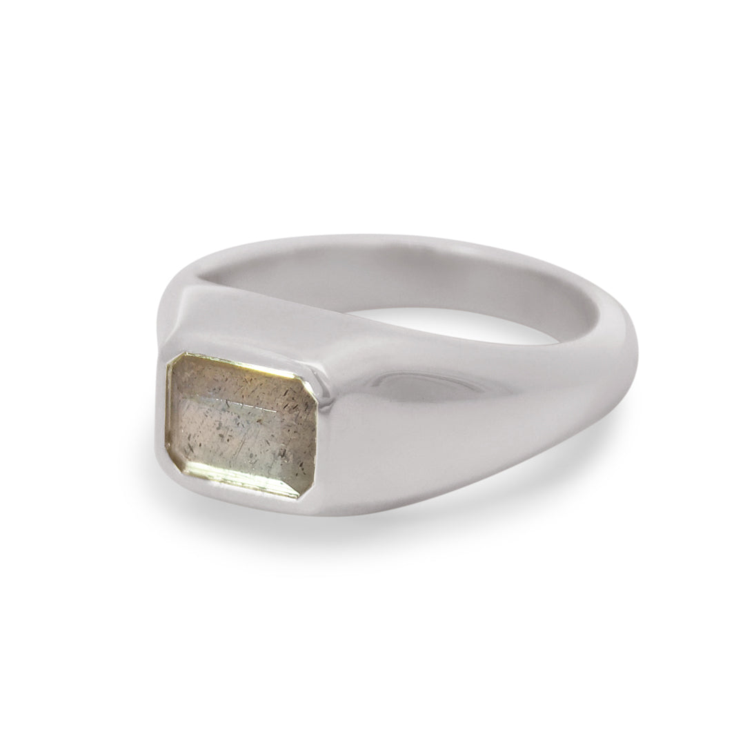 Silver ring with a rectangular stone on a white background