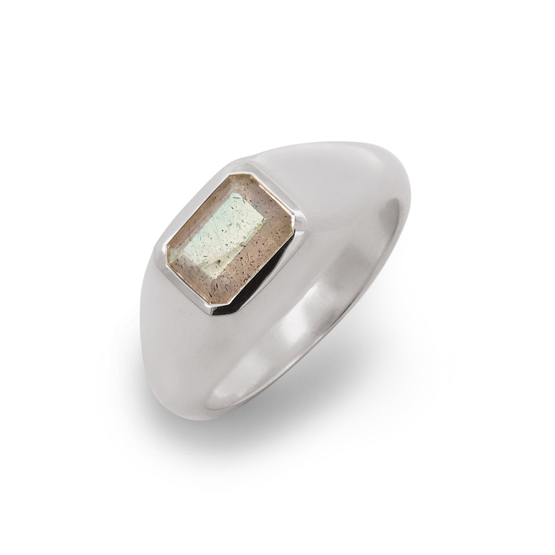 Silver ring with a rectangular stone on a white background