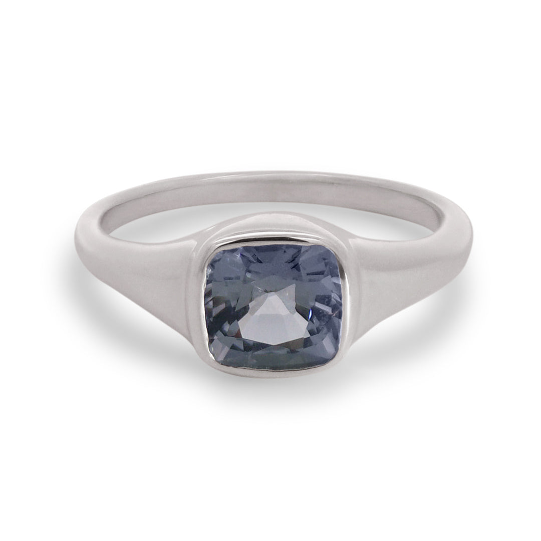 Silver ring with a blue gemstone on a white background