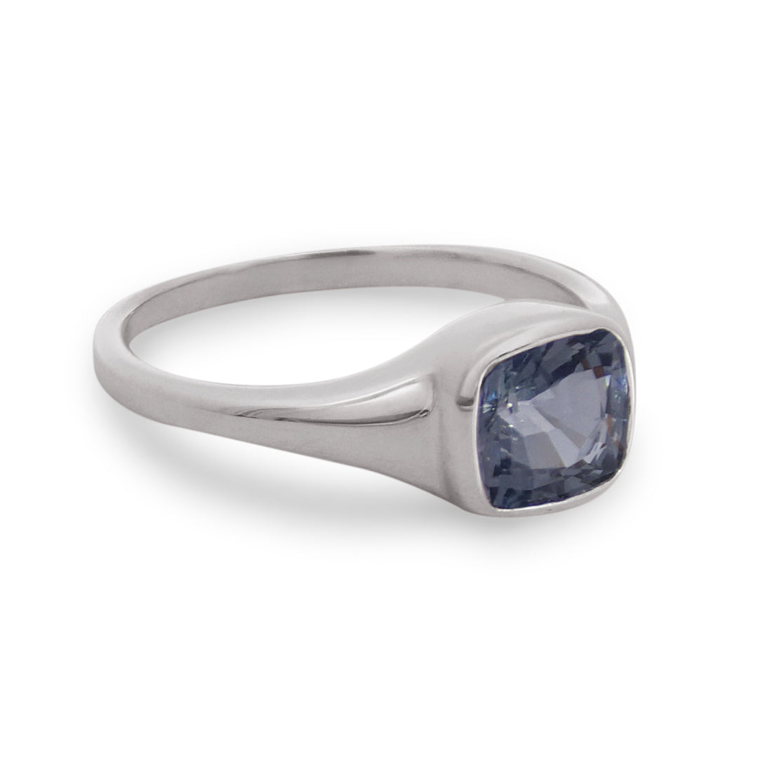 Silver ring with a blue gemstone on a white background