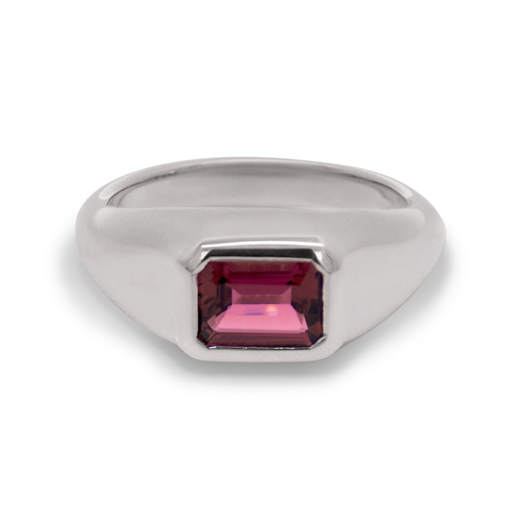 Silver ring with a pink gemstone on a white background