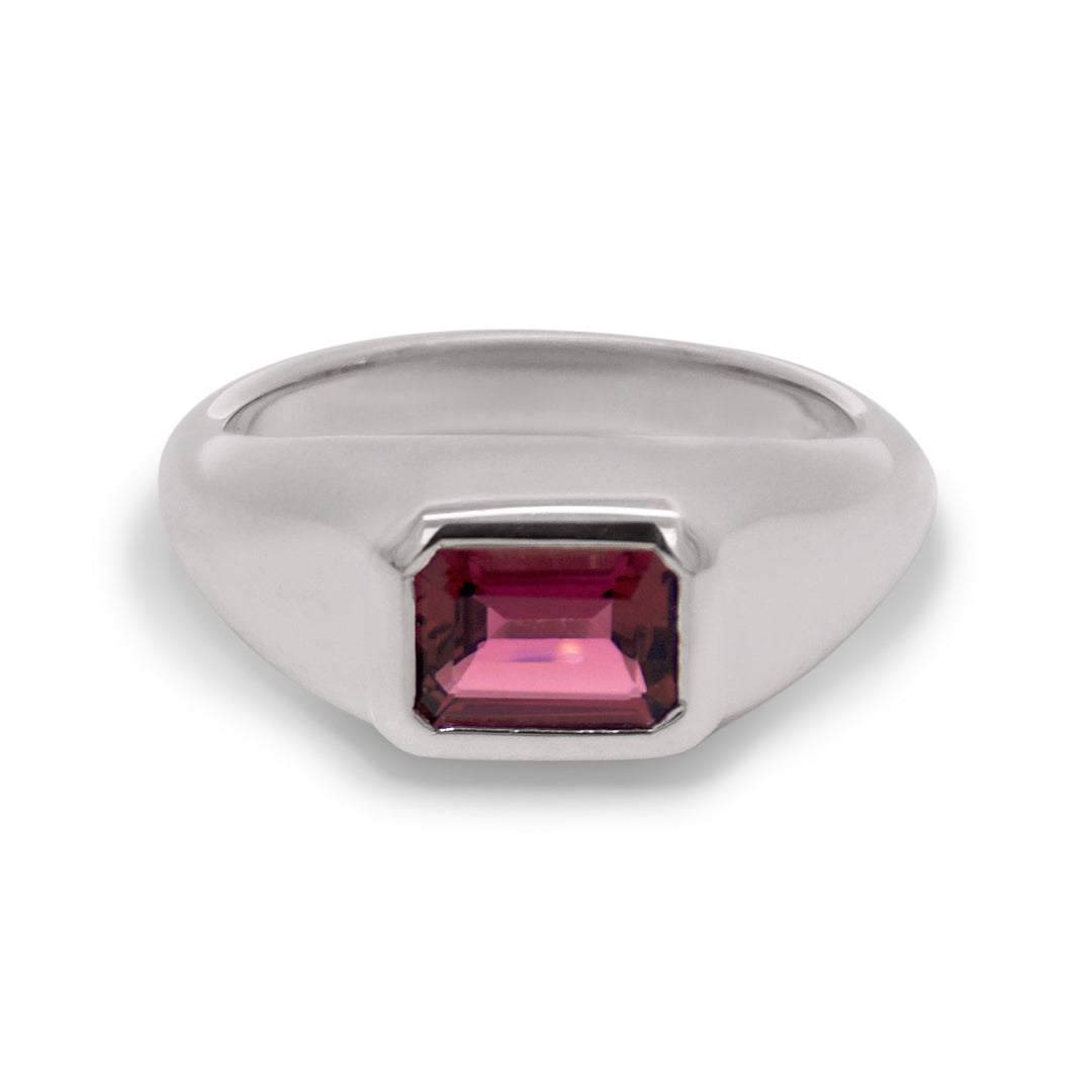 Silver ring with a pink gemstone on a white background