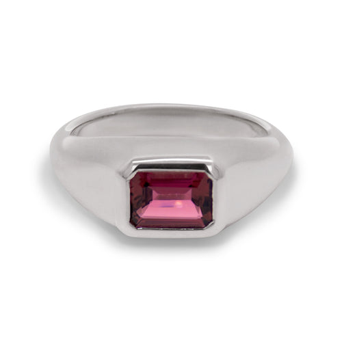 Silver ring with a pink gemstone on a white background