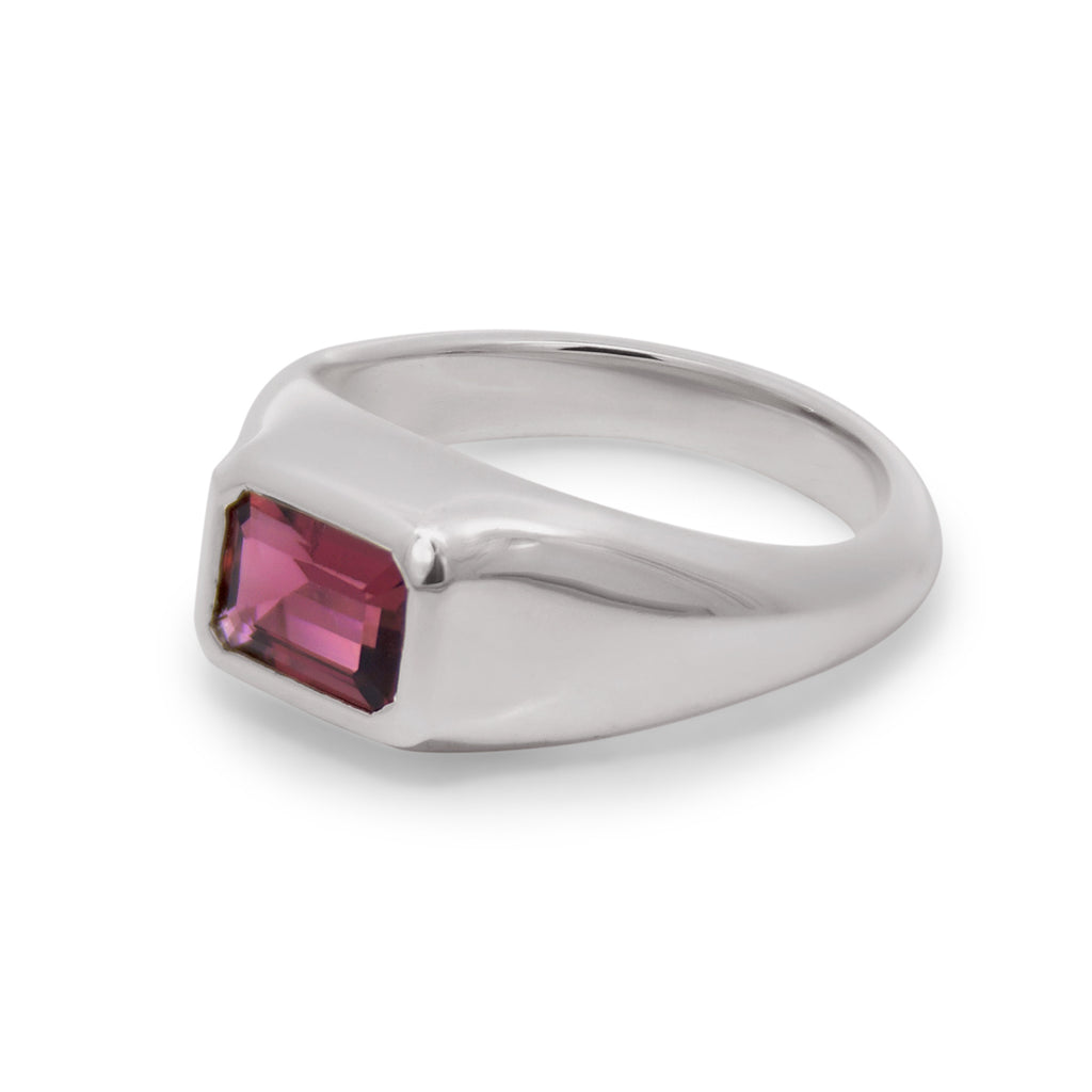 Silver ring with a square-cut red gemstone on a white background