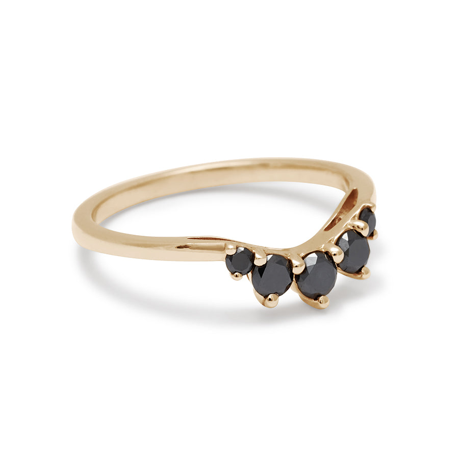 Angled view of a curved 5 black diamond band set in yellow gold.