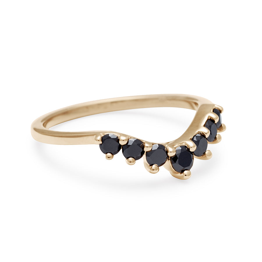 Angled view a curved 7 black diamond band set in yellow gold.