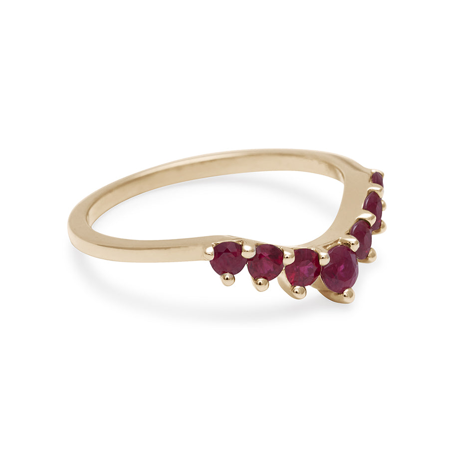 Side view of a curved 7 ruby band set in yellow gold.