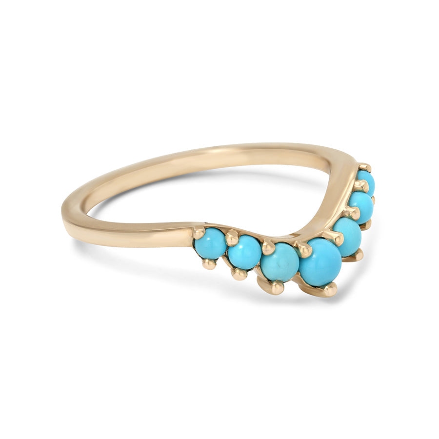 Side view of a curved 7 turquoise band set in yellow gold.
