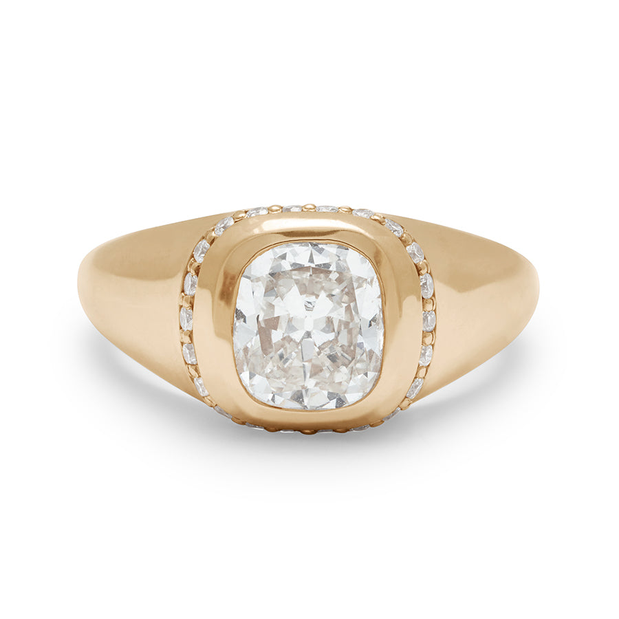 Front view of a cushion cut lab white diamond stone set in a signet style with a white diamond pave halo set in yellow gold.