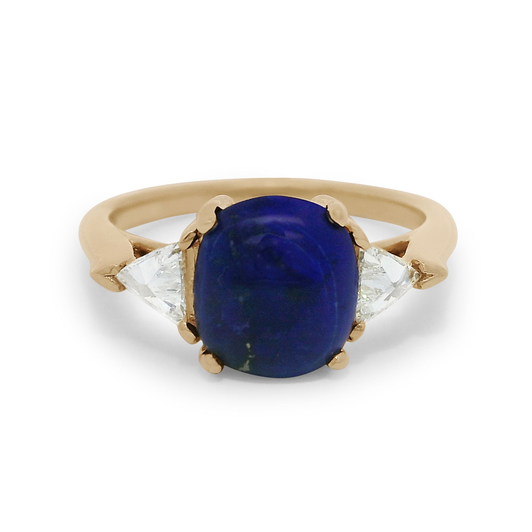 A lapis cabochon ring with white diamond trillion side stones set in 14k yellow gold. 