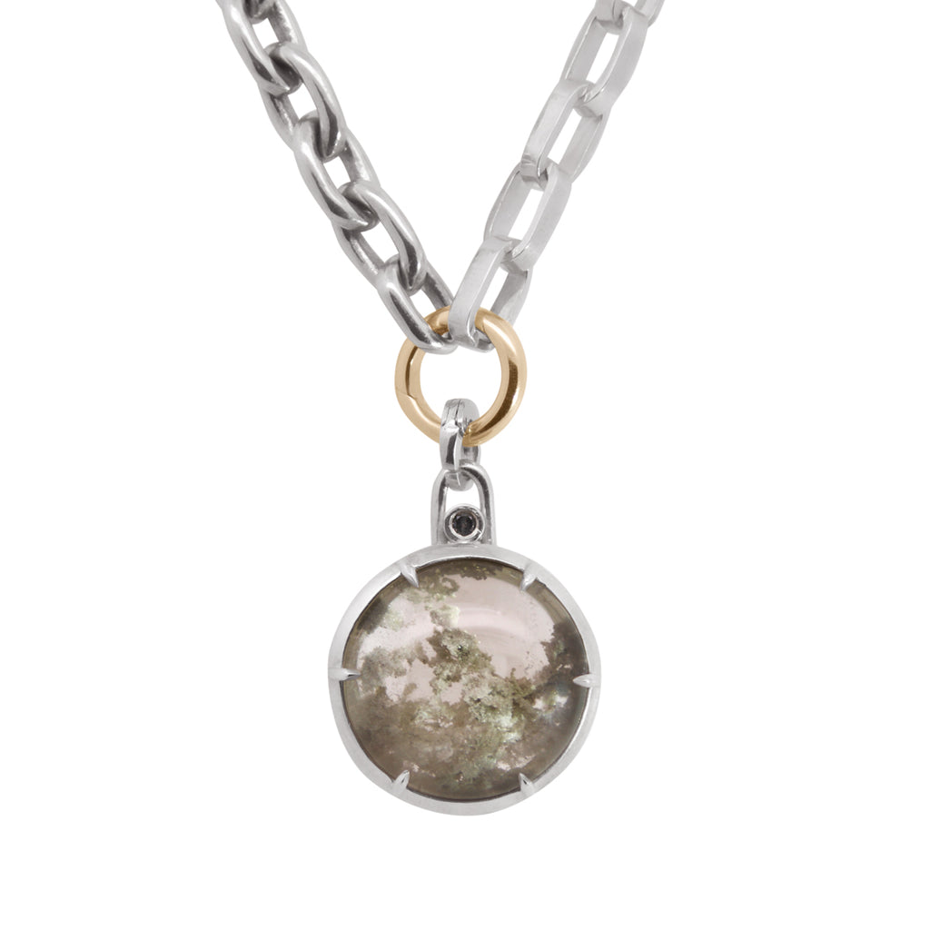 Silver chain with yellow gold O ring with a round greyish garden quartz pendant on a white background