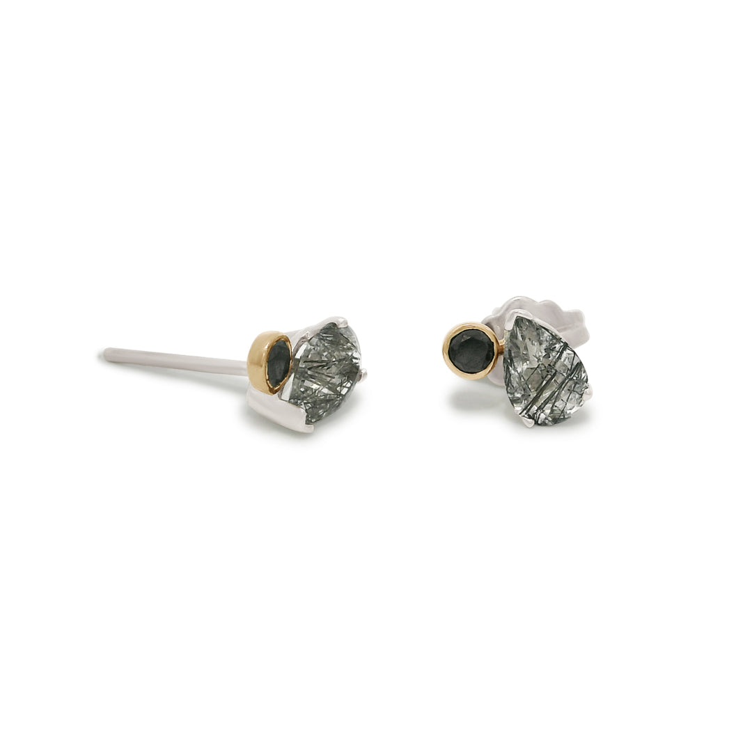 Pair of silver stud toi et moi earrings with black rutile quartz gemstones and round black diamonds on a white background