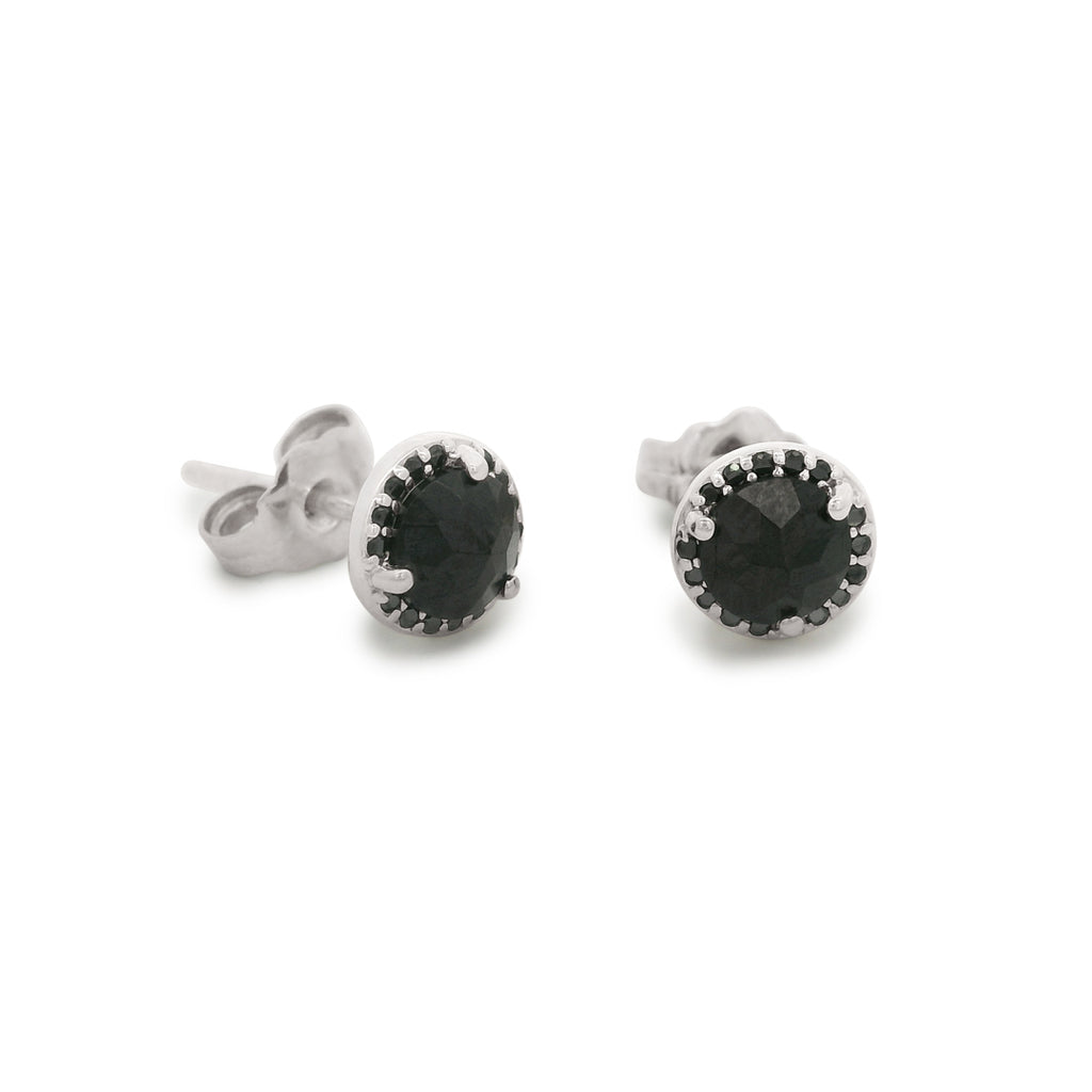 Pair of silver stud earrings with black gemstones on a white background