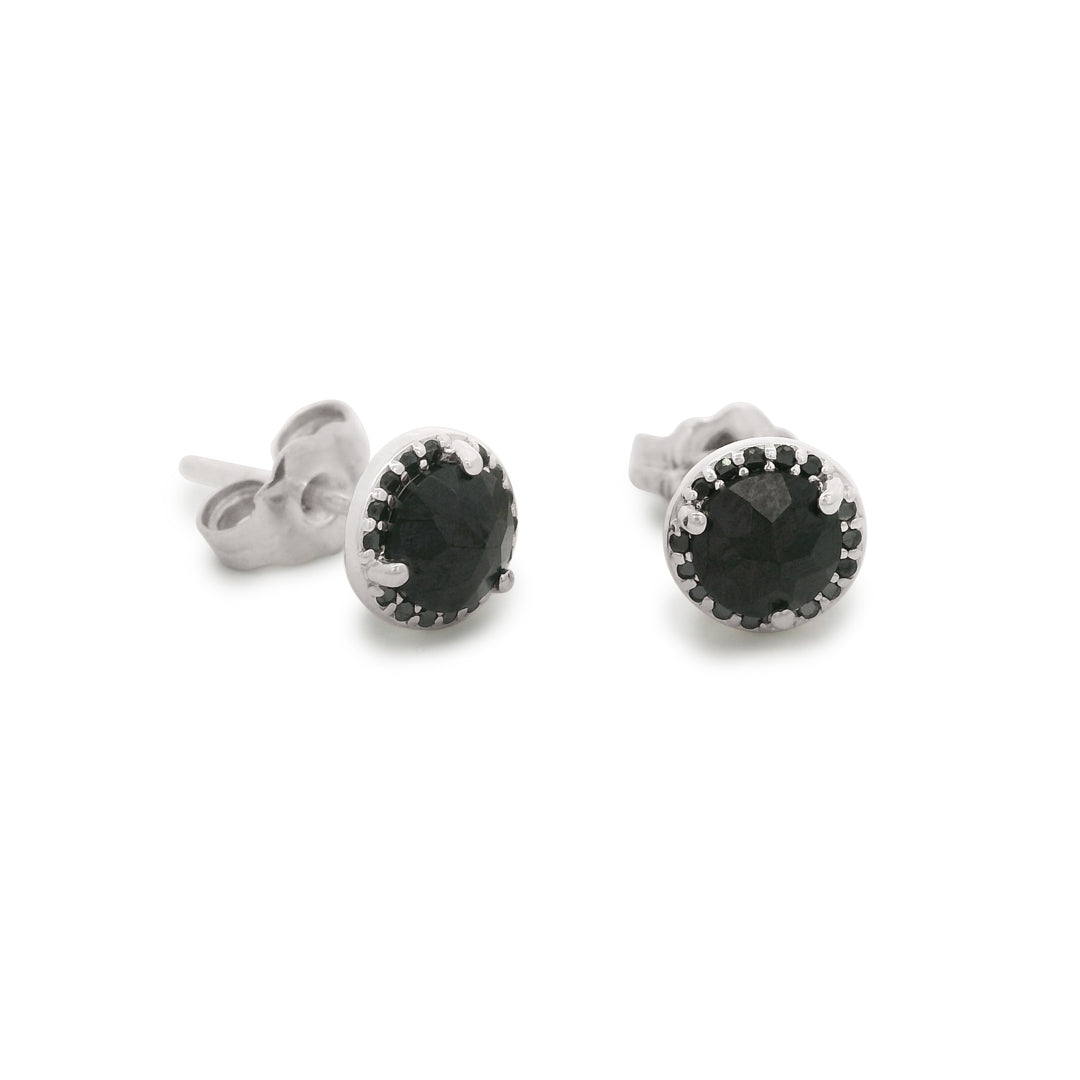 Pair of silver stud earrings with black gemstones on a white background