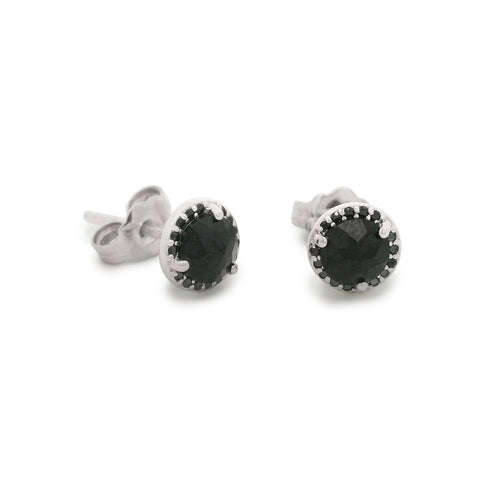 Pair of silver stud earrings with black gemstones on a white background