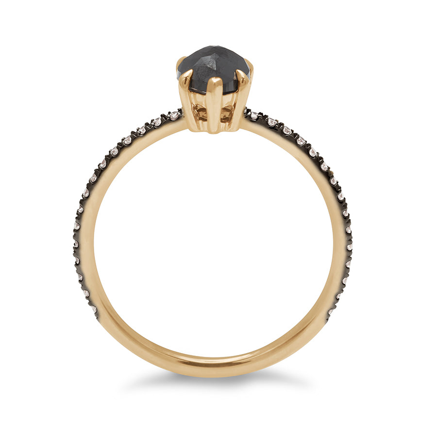 Side view of a solitaire pear shaped black diamond ring with claw prongs with white diamond pave on the band set in black rhodium and yellow gold.