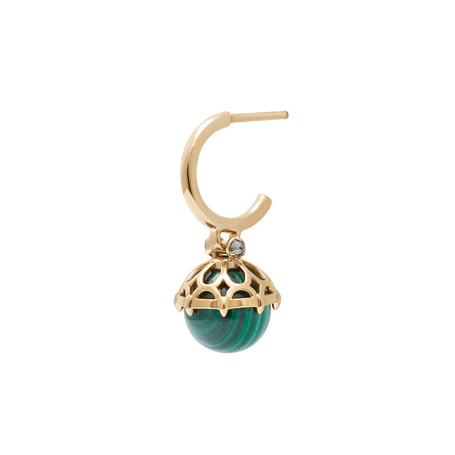 An angled view of a single hoop with a malachite stone hanging from it with grey diamond accents on either side set in yellow gold.