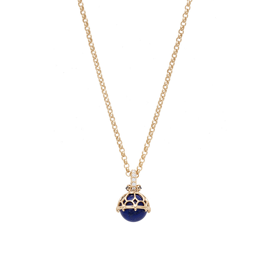 Zoomed out view of a one of a kind lapis pendant with white diamond pave on the top and grey diamond accent stones on either side on a yellow gold chain.