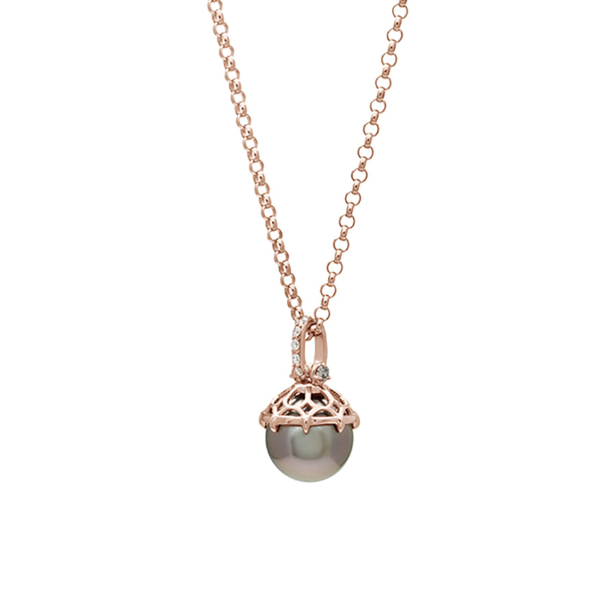 Zoomed out version of a one of a kind peacock pearl pendant with white diamond pave on the top and grey diamond accent stones on either side on a rose gold chain.