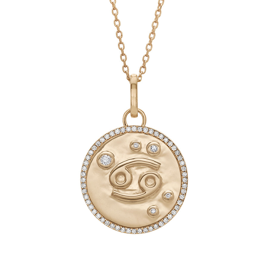 A 19mm constellation charm pendant with an Cancer sign in the center with white diamond accent stones and a white diamond halo set in yellow gold on a yellow gold chain., Cancer