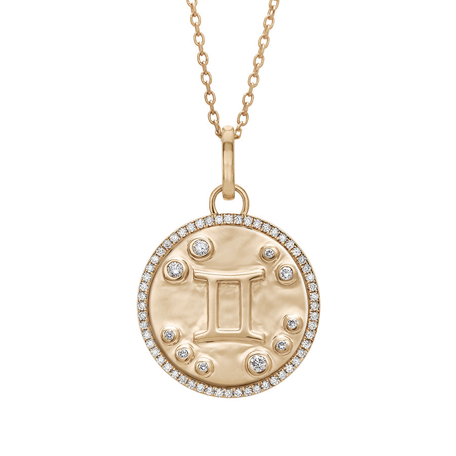 A 19mm constellation charm pendant with a Gemini sign in the center with white diamond accent stones and a white diamond halo set in yellow gold on a yellow gold chain., Gemini