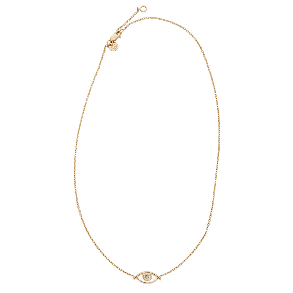 Zoomed out view of a choker with an evil eye charm with a champagne diamond in the center set on a yellow gold chain.