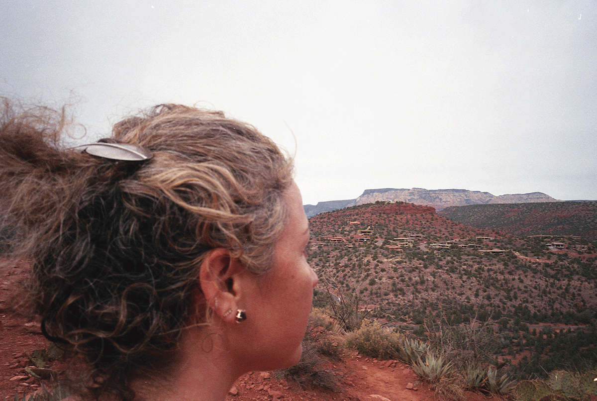 Anna Sheffield photographed in front of a mountain landscape.