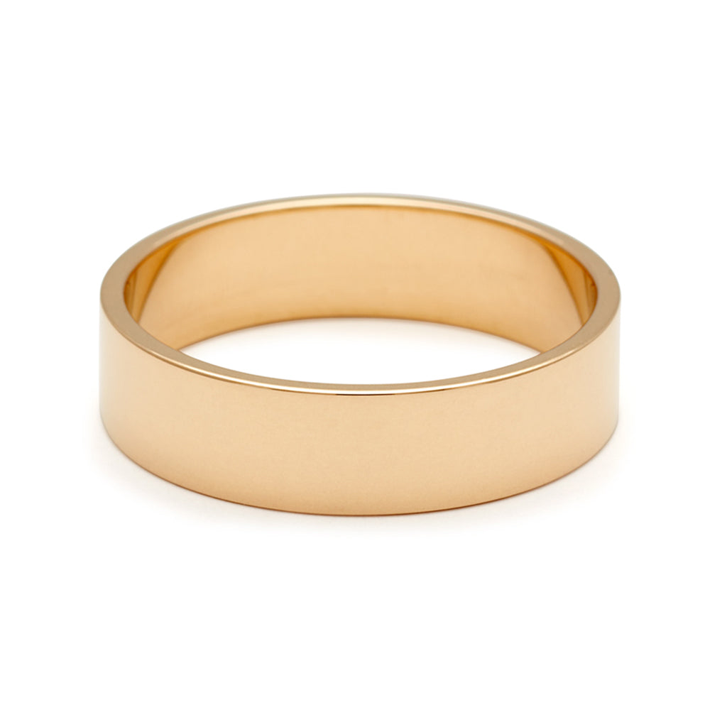 A 5mm flat band set in yellow gold.