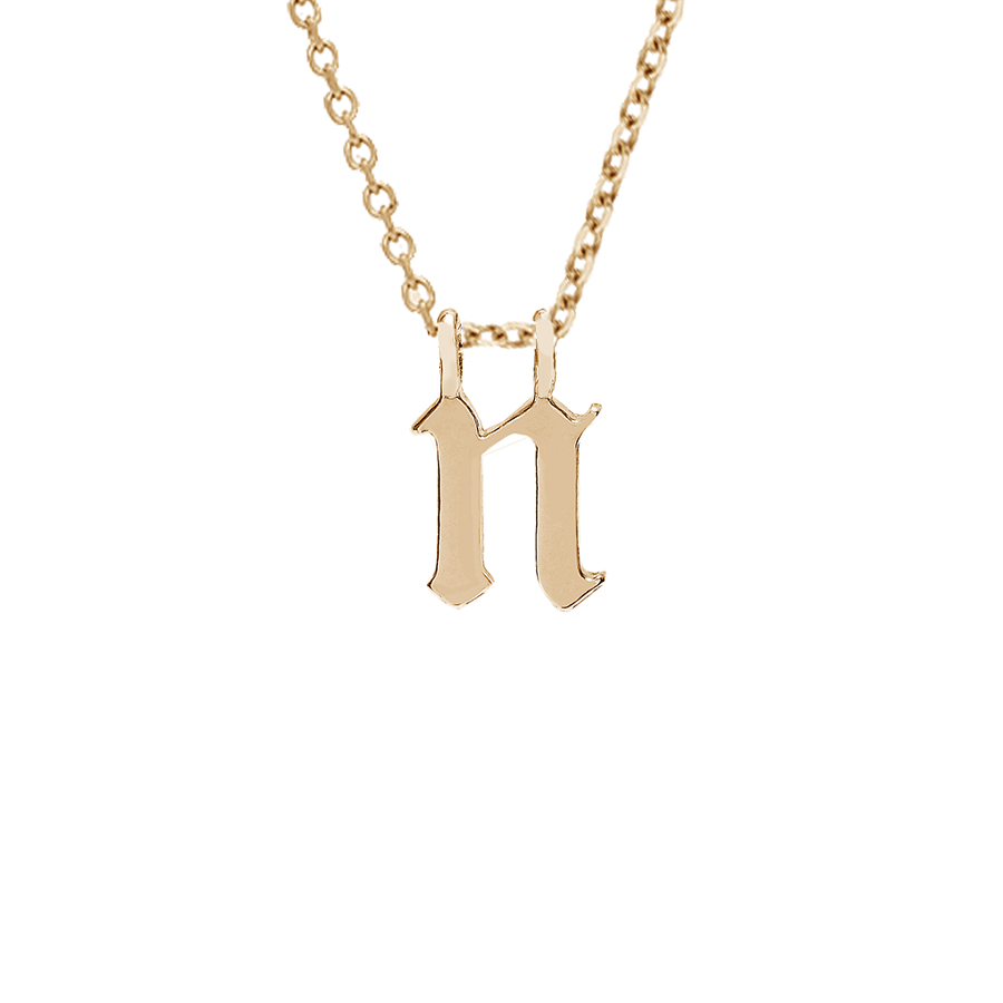 A "n" initial charm set in yellow gold on a yellow gold chain., Letter N