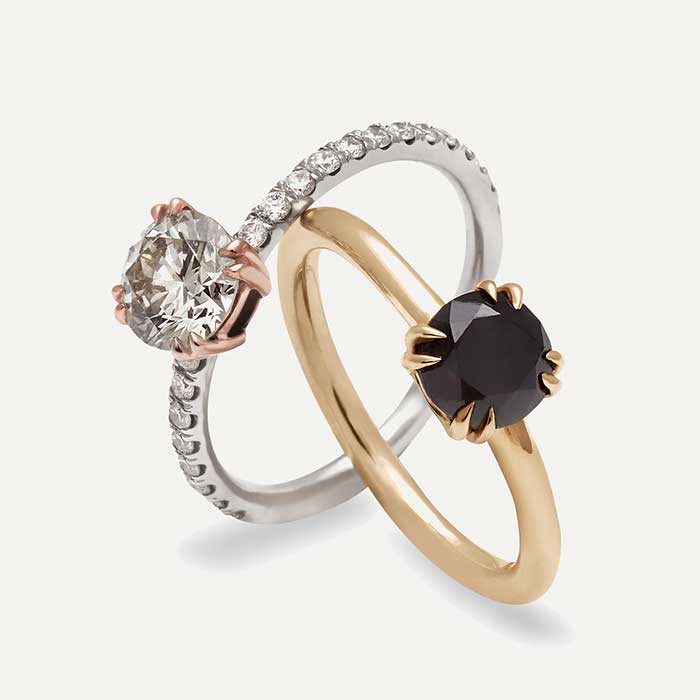 Two eleonore rings with claw rings, one champagne and one black diamond center stone.