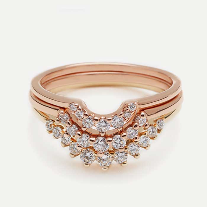 A suite of nesting bands with white diamonds in rose and yellow gold.