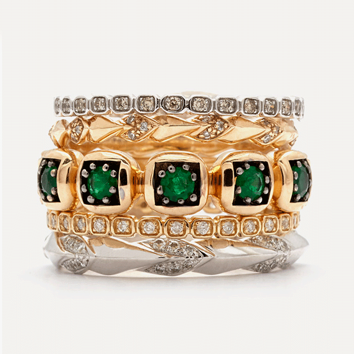 stacking bands in 14k gold mixed metal with white diamonds and emeralds by anna sheffield.