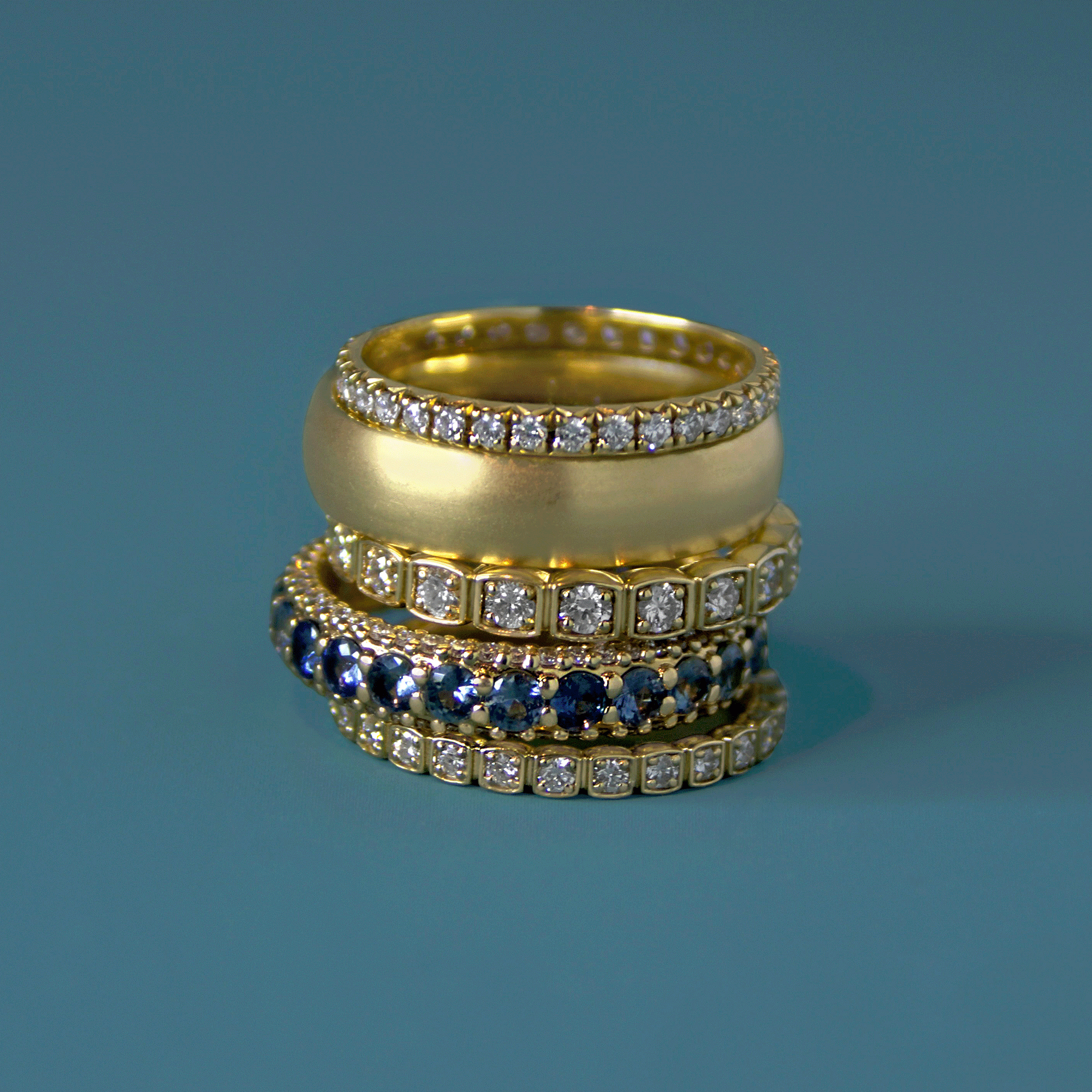 gold wedding band stack by anna sheffield made with white diamonds and montana sapphires